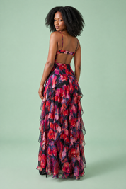 Robe longue noire asymétrique à manches cape et imprimé lys | Vue de dos | Lounelle Paris